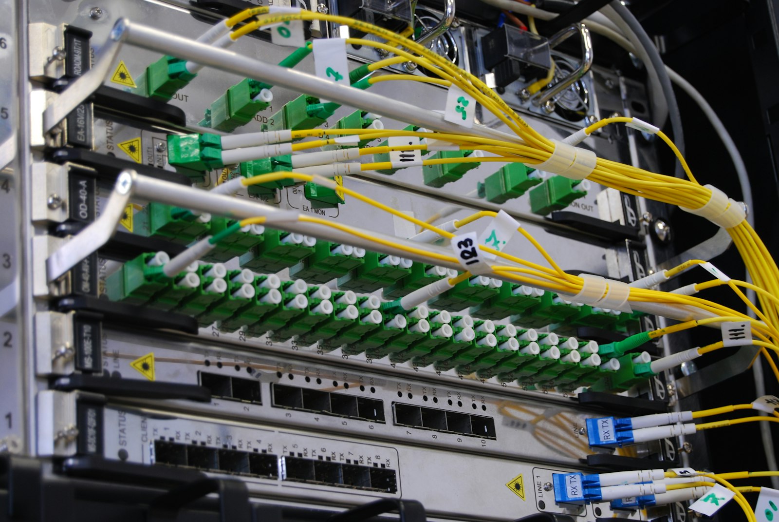 Technician organizing network cabling in a business server rack